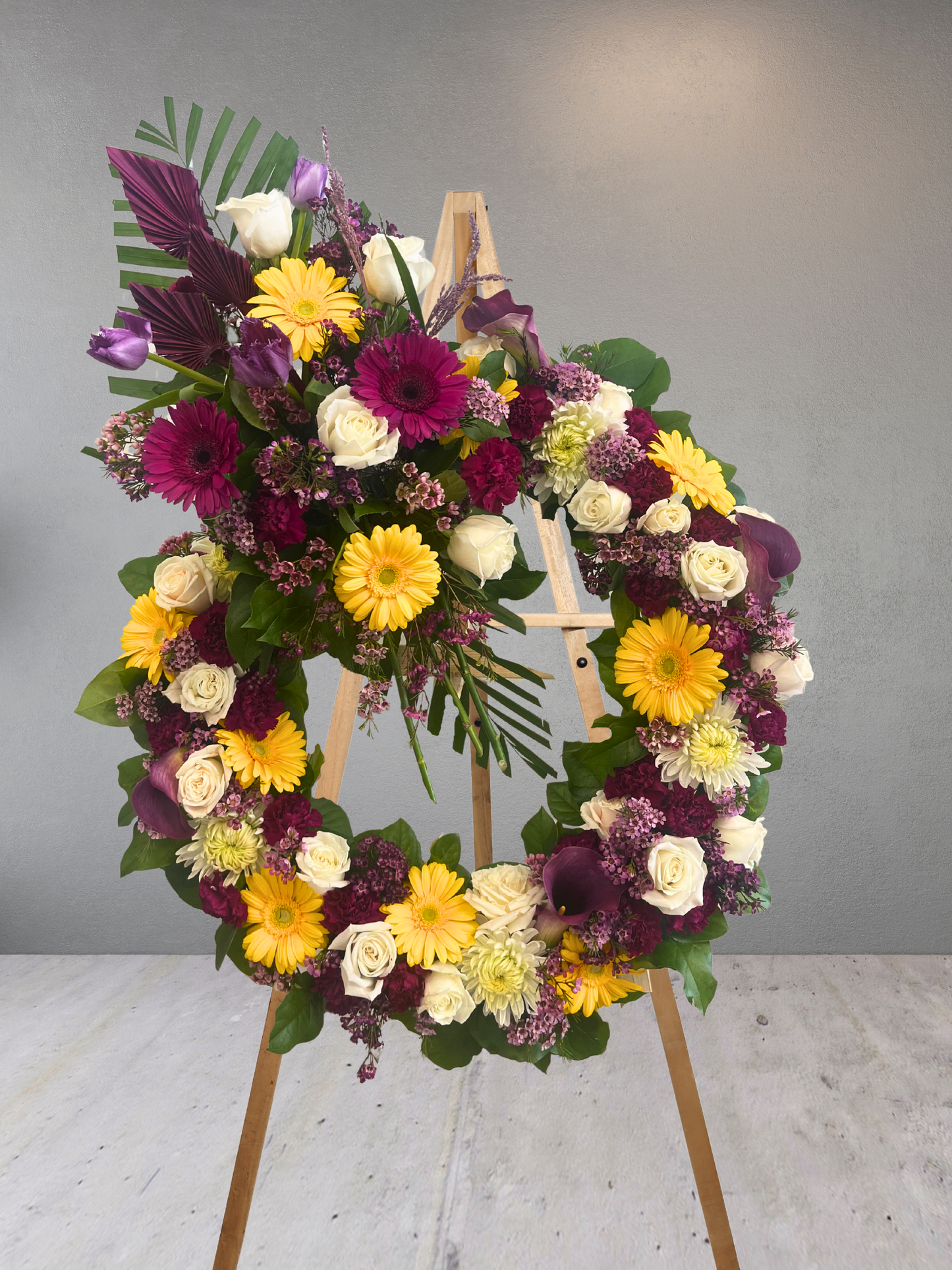 Purple and Yellow Funeral Wreath with Top Spray